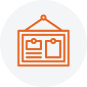 An orange line drawing of a picture frame with two rectangles inside, one larger and one smaller, hangs from a peg on a light gray circular background, symbolizing Public Info in Boundary County ID. | Boundary County ID
